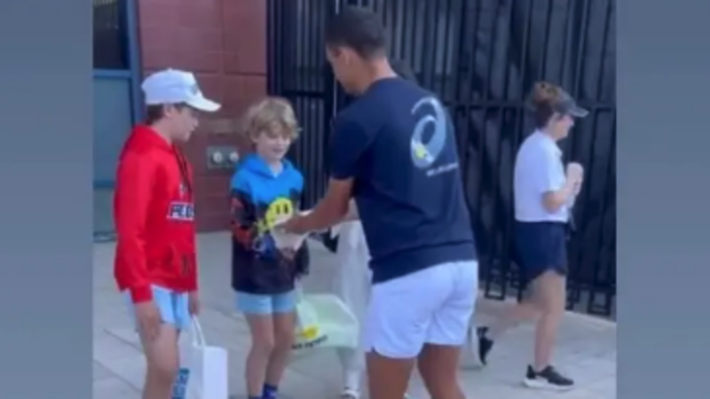 Professional Tennis Player Kamil Majchrzak Engages with Young Fan at US Open